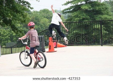 Inline skater jumping cone at skate park.