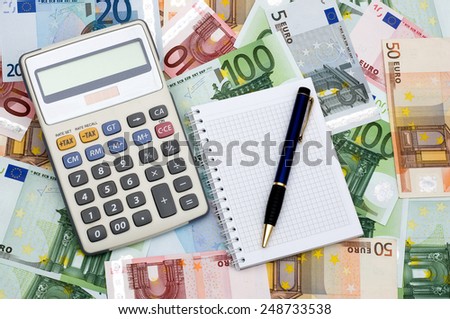 The calculator, notebook and the handle against money