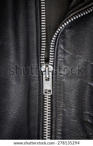 Close-up shot of a zip of black leather dress