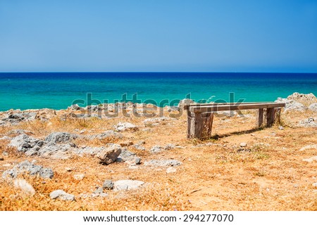 Beautiful wild beach with turquoise water and rocks. Place for relax. Malia, Crete island, Greece. Selective focus