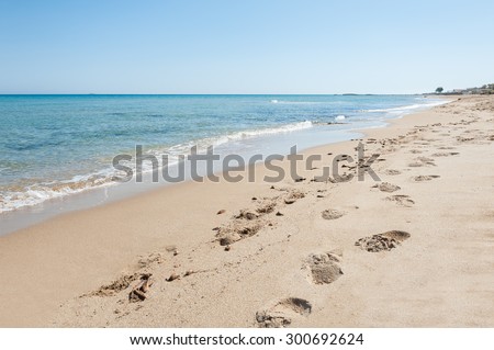 Beautiful tropical beach with turquoise water and white sand. Footprints on the sandy beach