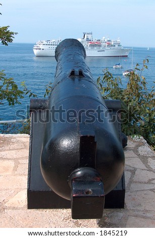 Big cannon aiming at cruise ship