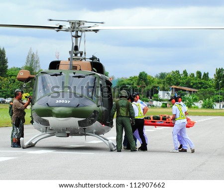 KORAT, THAILAND - SEP 15 : Military Rescue Team(white) pulling cart with wounded person to helicopter in Search and Rescue Exercise(SAREX) on September 15, 2012 in Nakhonratchasima,Thailand
