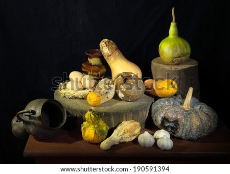 Expired pumpkins with garlic eggs as still life art photography