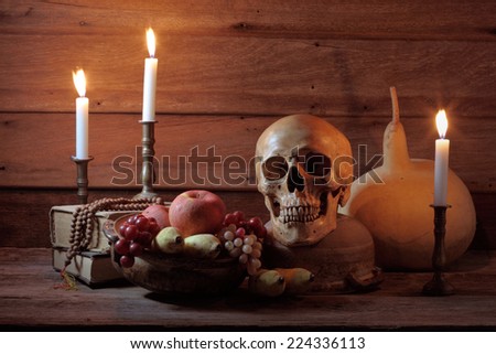 Still life art photography with skull and fruits bowl and books
