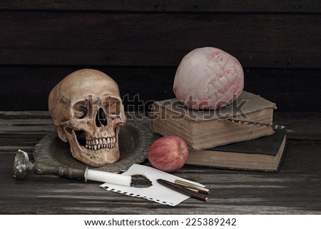 Still life art photography with skull and book anatomy education