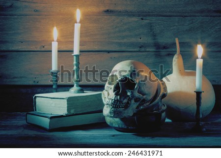 Still life art photography with skull and bowl and books