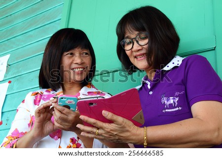 KORAT, THAILAND - FEB 26 : Female school teachers communication by social network appliction exchange their numbers on February 26, 2015 in Nakhonratchasima,Thailand