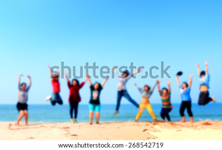 blur people jump at the beach