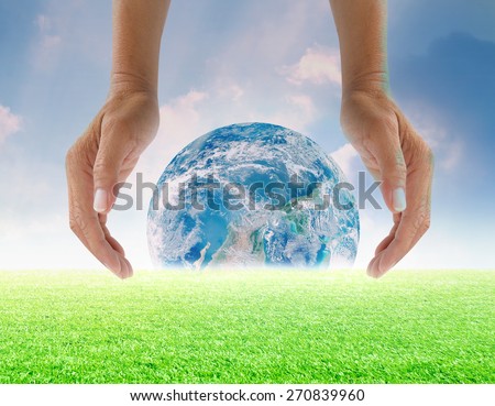 Human hands protect global Earth  over gas clouds and Sun a Think Earth Concept Elements of this image furnished by NASA