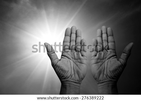 Praying hands over sparkly sun black and white version
