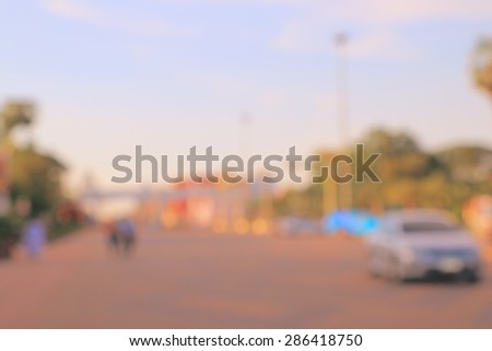 Blur cityscape on sunset with car people and road