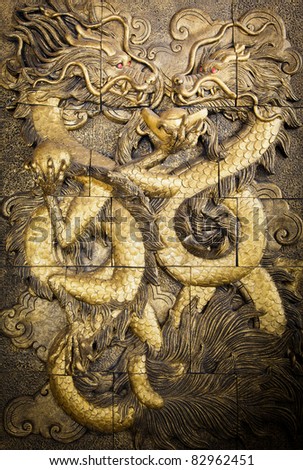 two Chinese style golden dragons fighting as low relief technique  mass product artwork