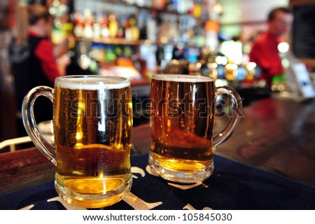 Two cups of beer in a pub in New Zealand. Concept photo of drinking beer and alcohol