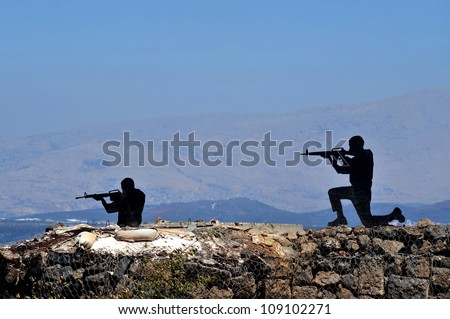 Silhouette of soldiers shooting in Mount Bental in the Golan Heights, Israel.