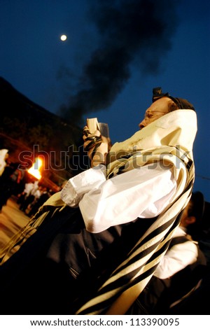 MT MERON - MAY 16: Ultra Orthodox Jewish man pray on Lag Bomer Jewish holiday at the tomb of Rabbi Simeon bar Yohai on May 16 2006 in mount Meron,Israel.It\'s honor his memory by lighting fire.