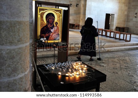 TIBERIAS - MAY 19: A nun inside the Church of the Multiplication at the Sea of Galilee, Israel on May 19 2009.It believed that this is where Jesus multiply the Loaves and Fishes.