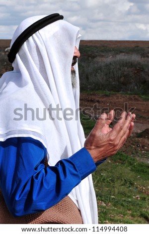 EREZ CROSSING, ISRAEL - DECEMBER 31:Muslim Palestinian Arab man pray to Allah on December 31 2009.According to Islamic belief, Allah is the proper name of God and humble submission to His Will