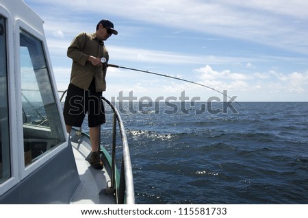 Fisherman holds a fishing rod during fishing safari.