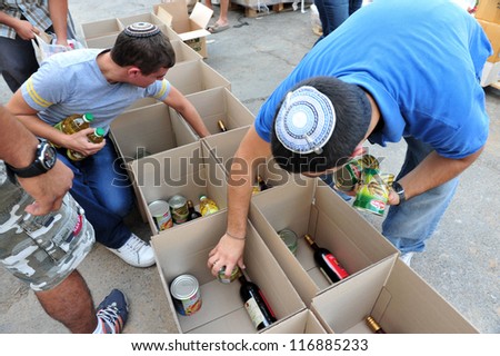 SDEROT - SEPTEMBER 15:Member of Chabad is giving food to poor Jewish families on September 15 2008 in Sderot,Israel.Chabad is an educational organization dedicated to help every Jew in the world.