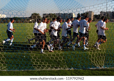 ASHKELON - APRIL 11: Soccer players running and warming up before a football game on April 11 2006 in Ashkelon, Israel. Soccer is the fastest growing and most popular sport in the world.