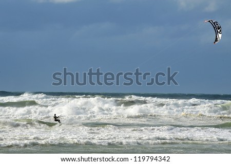ASHKELON - March 09: Kitesurfer is kite boarding on March 09 2011 in Ashkelon, Israel.In 2012, the number of kitesurfers estimated to 1.5 million persons world wide.