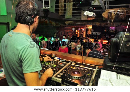 NETIVOT - AUGUST 24: Dj mixing in a night club on August 24 20in Netivot, Israel. Studies have shown that the average person will spend three to four hours per weekend in a Nightclub.
