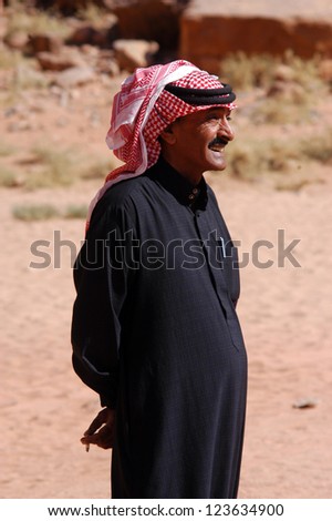 WADI RUM, JORDAN - NOV 10 2007:Jordanian Arab man wearing red Keffiyeh in Wadi Rum Jordan.It has been used by Arabs throughout the centuries and was used as symbol of honor and tribal identification.