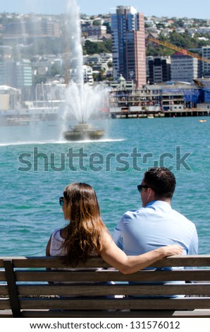 WELLINGTON - FEB 28:Couple sit on a bench in Oriental Bay on February 28 2013 in Wellington, New Zealand. It\'s the closest beache to the central city and a popular spot in Wellington.