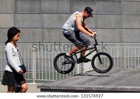 WELLINGTON - FEB 24: Young man is jumping with his BMX Bike on February 24 2013 in at Wellington waterfront, NZ. It became official Olympic sport in the 2008 Summer Olympic Games in Beijing, China.