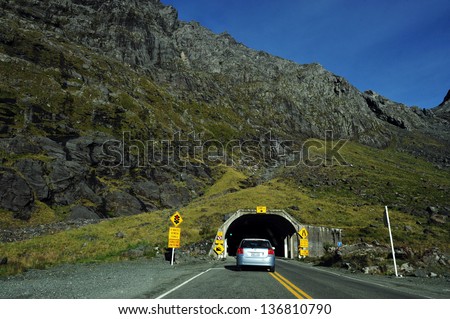 FIORDLAND,NZ - FEB 28:Cars enter Homer Tunnel on February 28 2009.It\'s a 1.2km (0.75 miles) road tunnel and until it was sealed and enlarged it was the longest gravel-surfaced tunnel in the world.