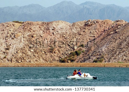 TIMNA, ISR - OCT 15:Visitors sail a peddle boat over Timna Lake  on October 15 2008.It\'s the worlds first copper production center founded my the Egyptian in the in Timna valley over 5000 years ago.