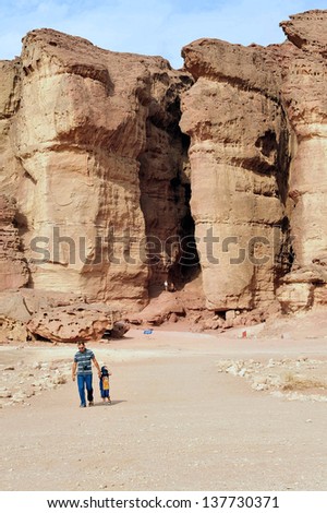 TIMNA, ISR - OCT 15:Visitors under Solomons pillars in Timna Park on October 15 2008.It\'s the world\'s first copper production center founded my the Egyptian in the in Timna valley over 5000 years ago
