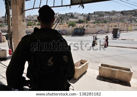 HEBRON, ISRAEL - SEP 08:Israeli soldier gourds on the Jewish quarter of Hebron on September 09 2009.Hebron is the site of the oldest Jewish community in the world, which dates back to Biblical times.