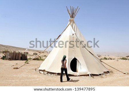 NEGEV,ISR - FEB 15:Woman live in Tipi on February 15 2011.Painted  plains Indians tipis were mainly featured geometric portrayals of celestial bodies, war battles and animal designs.