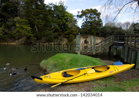 MATAKANA, NZ - JUNE 02: A Kayak on Matakana river bank on June 02 2013.kayaks can be useful in outdoor activities such as diving, fishing, wilderness exploration and search and rescue during floods.