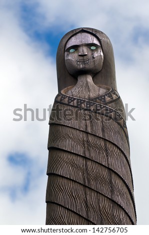 PIHA, NZ - JUNE 01:Sculpture of a Maori female on top of the Lion rock on June 01 2013.Maori are the indigenous people of NZ. Maori migrated to New Zealand FROM from Polynesia over 1000 years ago.