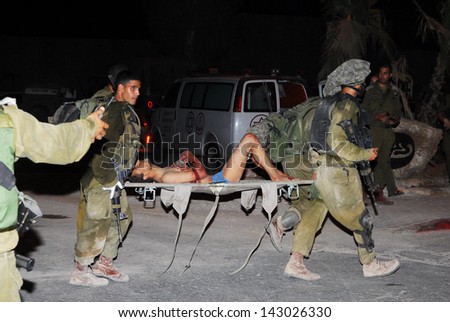 NACHAL OZ, ISR - AUG 02:Fatah men are fleeing into Israel with the help of Israel\'s Defense Force and emergency services after bloody clashes in the Gaza Strip on August 2, 2008 in Nachal Oz, Israel.