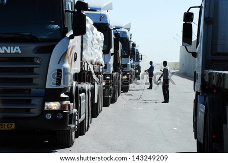 KEREM SHALOM CROSSING, ISR - FEB 04: Line of cargo trucks on Feb 04 2009. The crossing is used by trucks carrying goods from Israel to the Gaza Strip. In 2012, the rate of traffic was 250 trucks a day