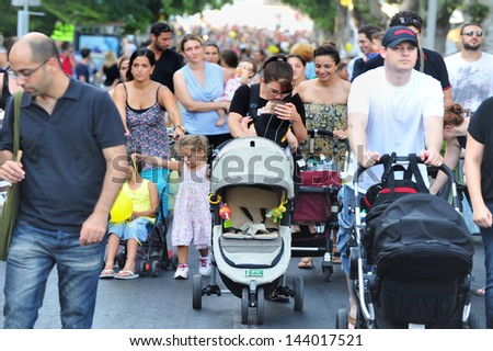 TEL AVIV - JULY 28 :Israeli parents during the \'strollers march\'  on July 28 2011.Thousands of parents across Israel stage \'strollers march\' in protest of the high costs of raising a child in Israel.