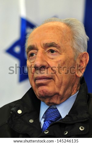 KIBBUTZ EREZ,ISR - APR 13 :Portrait of Israel President Shimon Peres un the National flag of Israel on April 13, 2011.Shimon Peres  is regarded as the father of Israel\'s atom bomb.