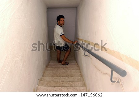 NAHARIA, ISR - JULY 21:Israeli man enters bomb shelter during 2006 Lebanon war on July 21, 2006.The State of Israel requires all buildings to have access to air raid shelters from 1951.