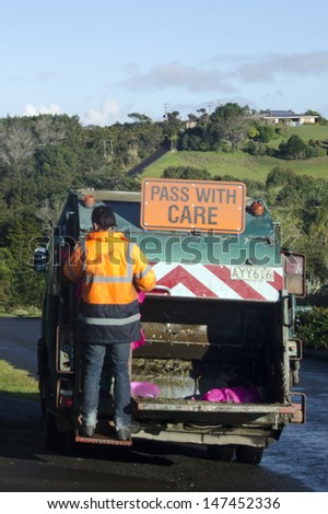 CABLE BAY, NZ - JULY 25:Waste management worker on July 25 2013. The number of landfills in NZ decreased since 1995 from 327 to less than 100 today and most of New Zealand recycle is sent to China.