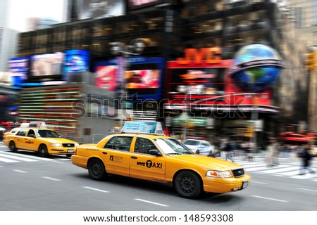 NEW YORK CITY - OCT 15 2010:New York City yellow taxi cabs race through Time Square.It\'s one of the world\'s busiest pedestrian intersections and a major center of the world\'s entertainment industry.