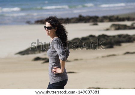 Pretty 30 years old woman with confident smile portrait at the beach during beach holiday. Concept photo of women freedom, travel, vacation ,happy, happiness, solo, alone, single, fun.