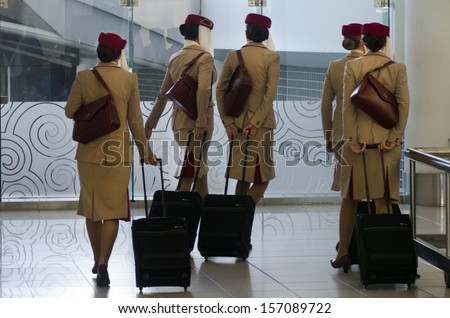 AUCKLAND - SEP 15:Emirates Airlines flight attendants in Auckland International Airport on Sep 15 2013.Emirates Airline was voted Airline of the Year in 2013.