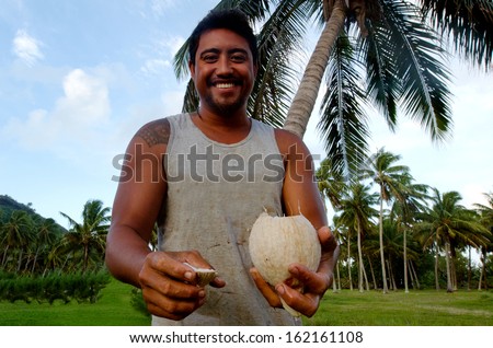 AITUTAKI - SEP 17:Cook islander drinks fresh coconut from the tree on Sep 17 2013.Coconut is a very versatile and indispensable fruit.It\'s a complete food rich in calories, vitamins, and minerals.