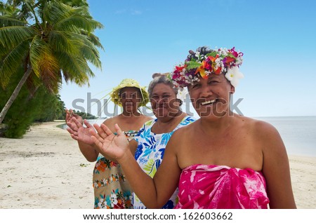 Portrait of Polynesian Pacific Island Tahitian mature females smiles and wave haloha, hellow,  on the beach in Aitutaki lagoon Cook Islands.