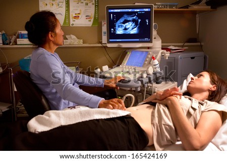 KAITAIA, NZ - NOV 05:Ultrasound scanning in the x-ray lab on Nov 05 2013.A pregnancy ultrasound is an imaging test that uses sound waves to see how a baby is developing in the womb.