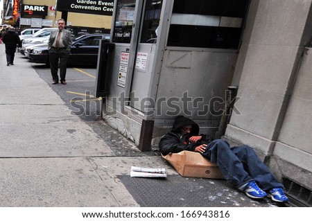 NEW YORK CITY - NOV 11: A homeless man sleeps on the streets Nov 11, 2009 in New York, New York.A 2013 report show that the number of homeless people recorded in NYC topped 50,000 for the first time.